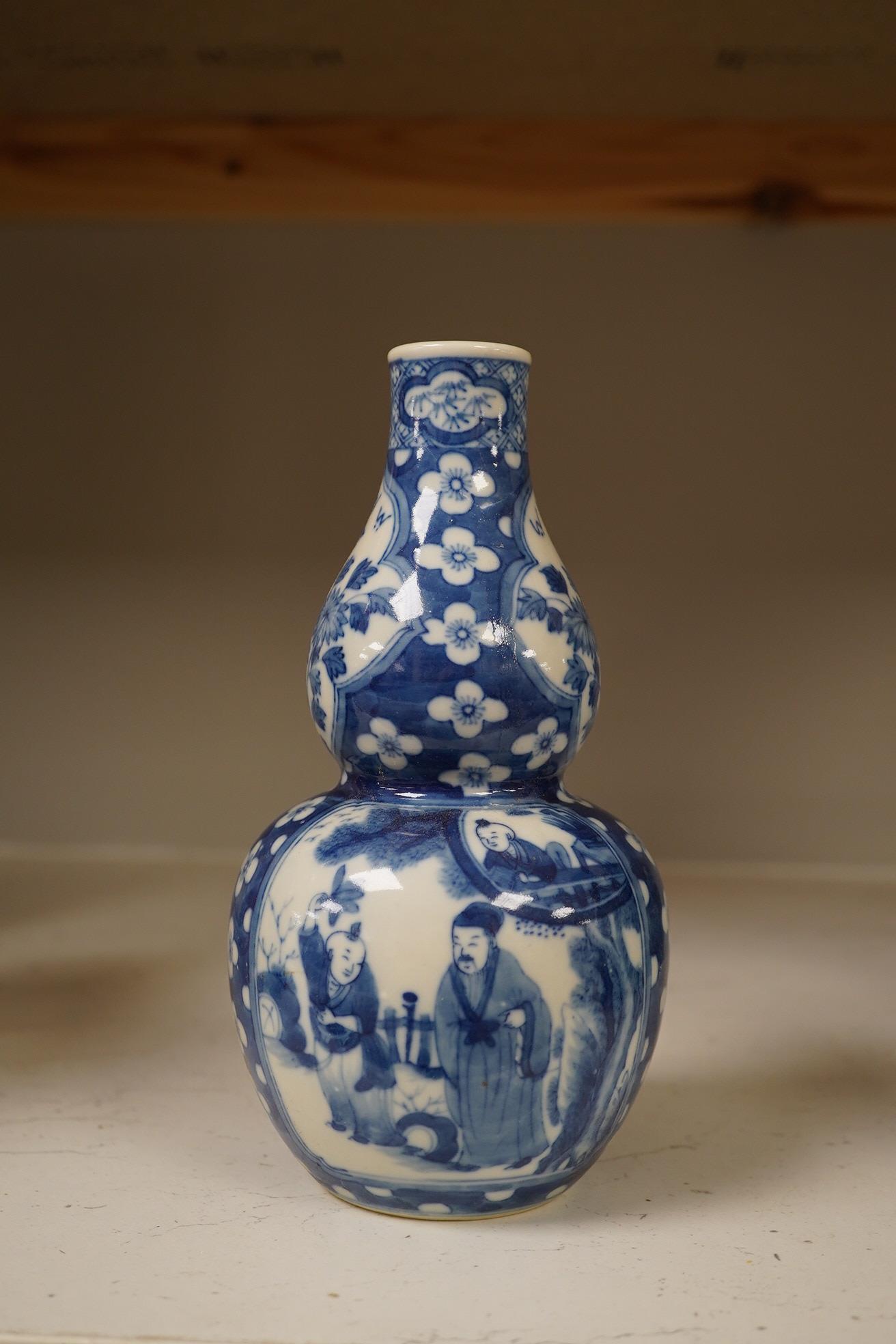 Two Chinese vases; a blue and white double gourd vase and famille noir vase, famille noir 19cm high. Condition - good